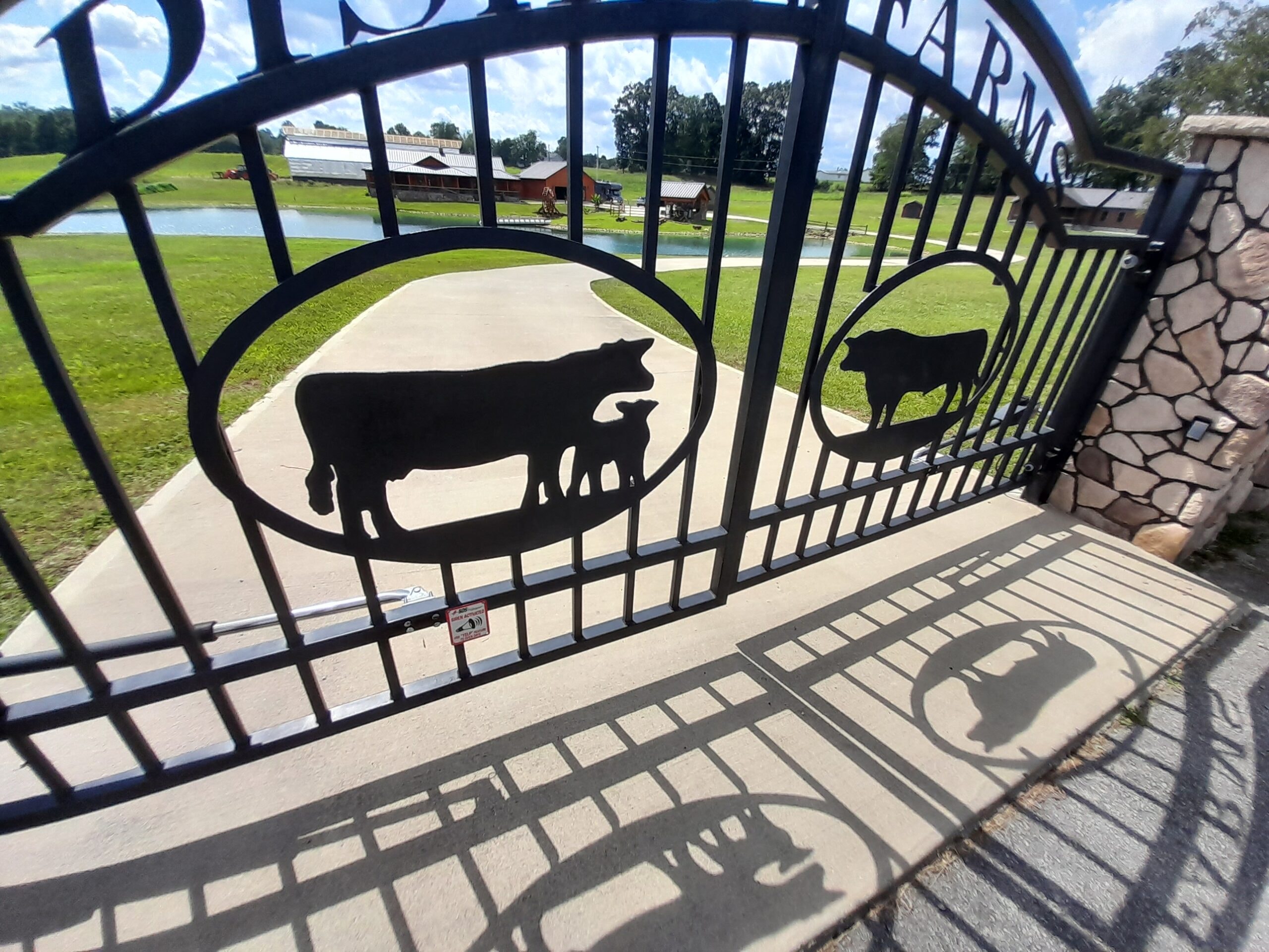 Decorative farm gate with cattle silhouettes